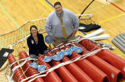 
Rhino Sports has donated four volleyball sets that can be adjusted for racquetball and pickle ball to Spokane Valley HUB. HUB director Jon Delonas and employee Audra Hess show it off. 
 (J. BART RAYNIAK / The Spokesman-Review)
