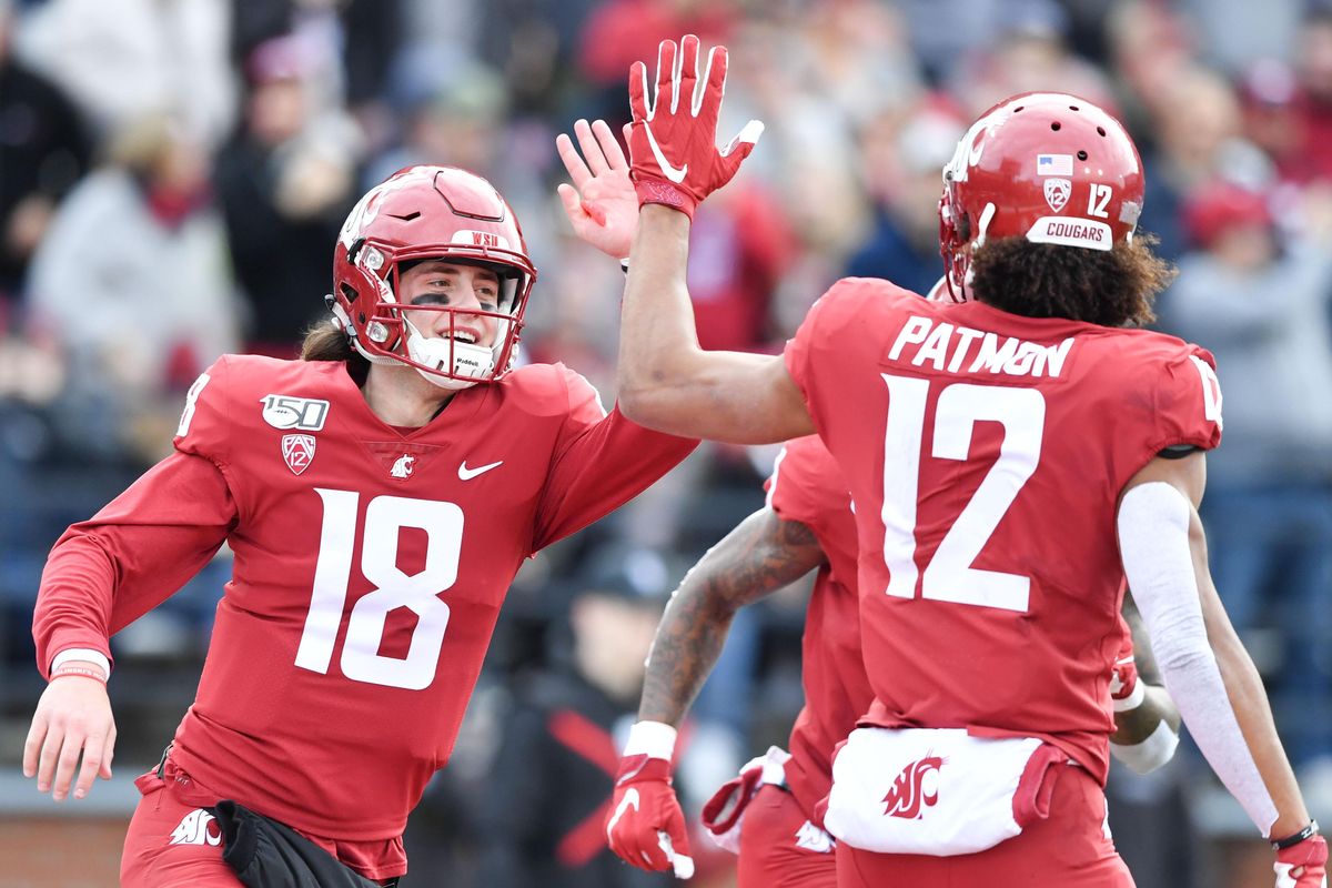 Washington State Cougars quarterback Anthony Gordon (18) high fives Washington State Cougars wide receiver Dezmon Patmon (12) after scoring during the first half of a college football game on Saturday, November 16, 2019, at Martin Stadium in Pullman, Wash. (Tyler Tjomsland / The Spokesman-Review)