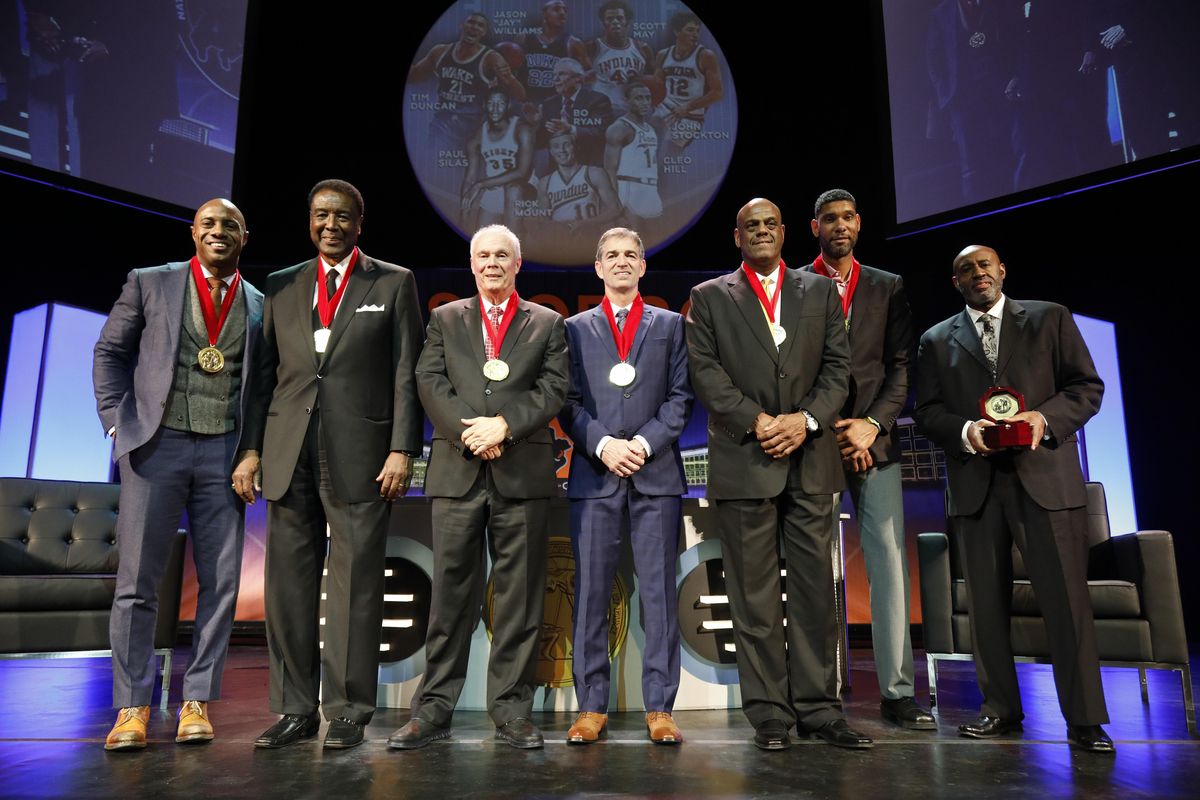 The Class of 2017 from left, Jason Williams, Paul Silas, Bo Ryan, John Stockton, Scott May, Tim Duncan and Cleo Hill Jr. stand on stage with their medals at the conclusion of a National Collegiate Basketball Hall of Fame induction event, Sunday, Nov. 19, 2017, in Kansas City, Mo. (Colin E. Braley / Associated Press)
