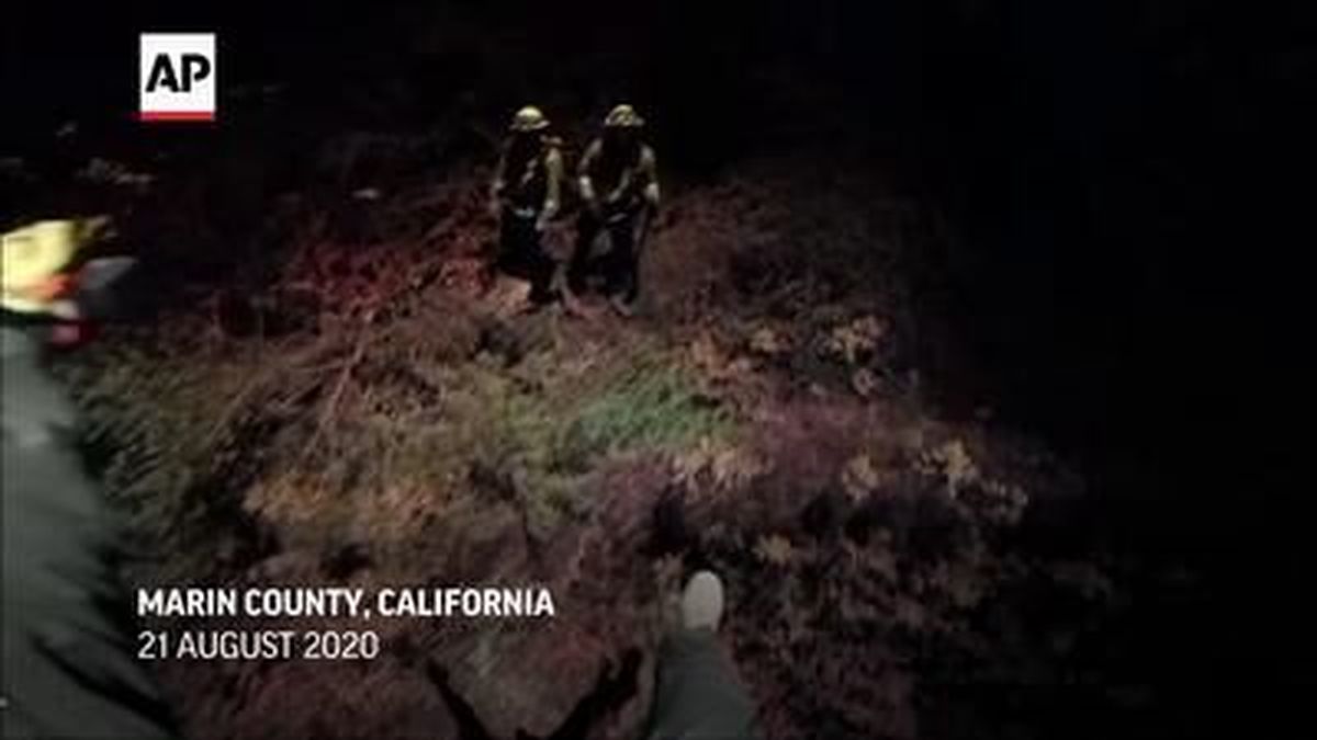 Two California firefighters with the Marin County Fire Department were saved on Friday night, as they were suddenly trapped by flames from the Woodward Fire, near Point Reyes. 