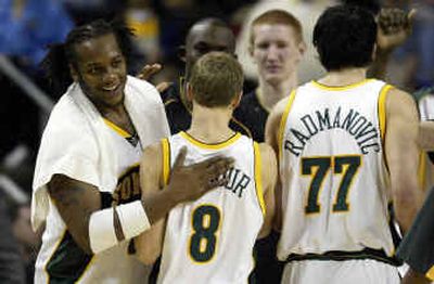 Danny Fortson of the SuperSonics, left, greets Luke Ridnour and Vladimir Radmanovic during a timeout against the Indiana Pacers last Sunday, moments before Seattle improved to 13-2.
(Associated Press / The Spokesman-Review)