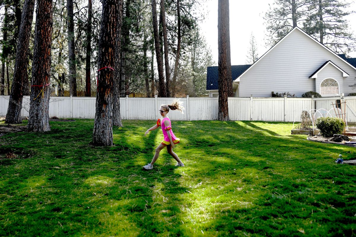 Ten-year-old Morgan Herr competes in the Lake City Figure Skating virtual competition from her back yard in Spokane on Saturday, April 4, 2020. (Kathy Plonka / The Spokesman-Review)