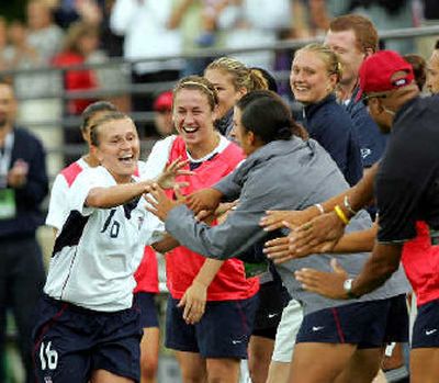 
U.S. forward Tiffeny Milbrett, left, celebrates with teammates on the sideline after scoring her 100th career international goal in the second half against Ukraine.
 (Associated Press / The Spokesman-Review)