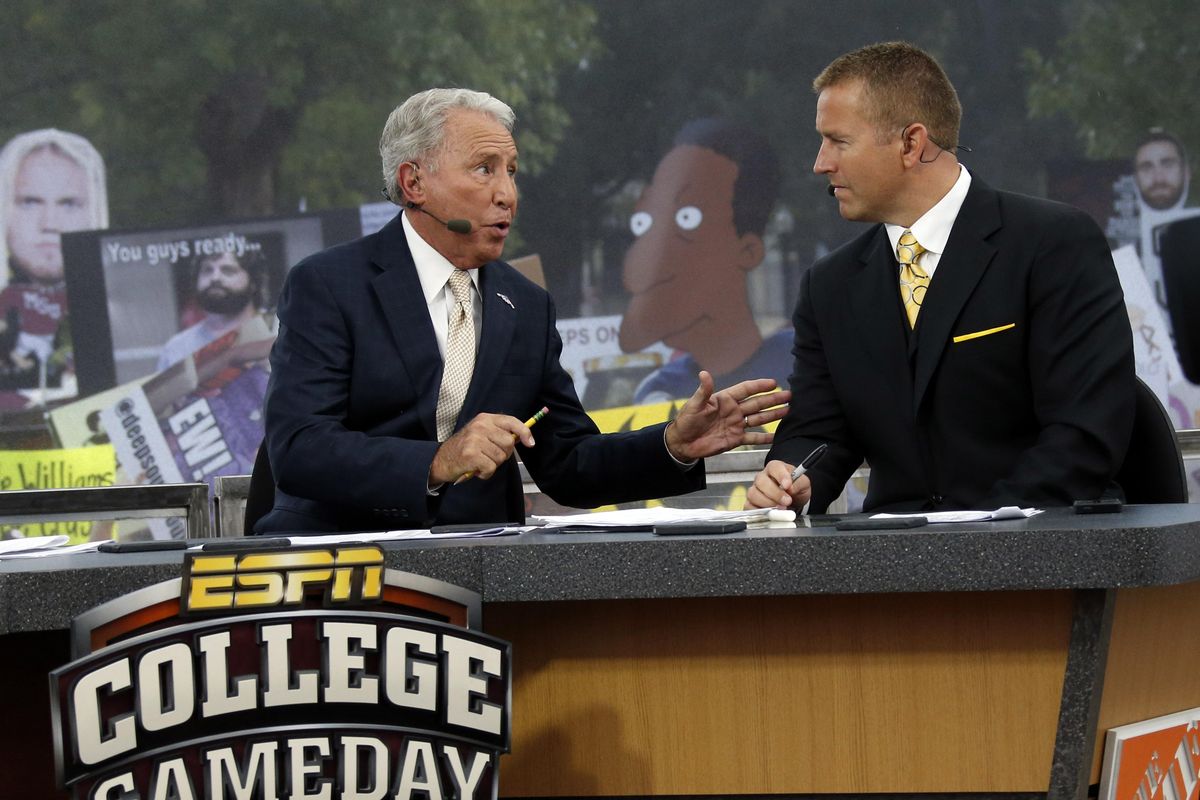 ESPN College GameDay hosts Lee Corso, left, and Kirk Herbstreit confer during the telecast from The Junction prior to Mississippi State playing Auburn  in Starkville, Miss., on Oct 11, 2014. (Rogelio V. Solis / AP)