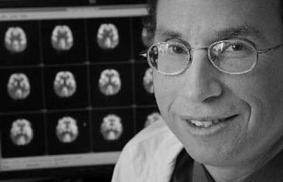 
Dr. Andrew Newberg, director of the Center for Spirituality and the Mind at the University of Pennsylvania School of Medicine, poses with images of brain scans at the Hospital of the University of Pennsylvania in Philadelphia. 
 (Associated Press / The Spokesman-Review)