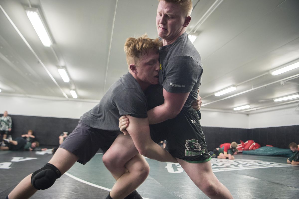 East Valley wrestler Winston Scott, left, attacks coaching assistant Hayden Stevens, right, during practice Tuesday at East Valley High School. Scott wrestles at 195, but may drop to 182. (Jesse Tinsley / The Spokesman-Review)