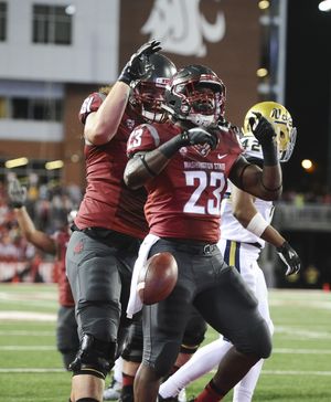 Washington State Cougars running back Gerard Wicks (23) celebrates the end zone after punching through the line to score against UCLA during the first half of a Pac-12 college football game on Saturday, Oct. 15, 2016, Martin Stadium in Pullman. (Tyler Tjomsland / The Spokesman-Review)