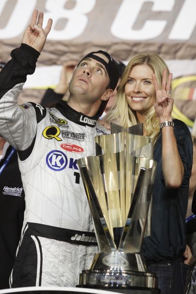 ORG XMIT: HMS153 NASCAR driver Jimmie Johnson and his wife, Chandra, displays three fingers after winning the NASCAR Sprint Cup Series championship for the third consecutive year on Sunday, Nov. 16, 2008, in Homestead, Fla. (AP Photo/Terry Renna) (Associated Press / The Spokesman-Review)