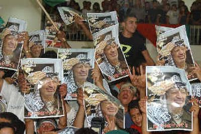 
Palestinians holding posters of Palestinian leader Yasser Arafat gather at his compound to show their support Saturday in the West Bank town of Ramallah. Palestinians holding posters of Palestinian leader Yasser Arafat gather at his compound to show their support Saturday in the West Bank town of Ramallah. 
 (Associated PressAssociated Press / The Spokesman-Review)