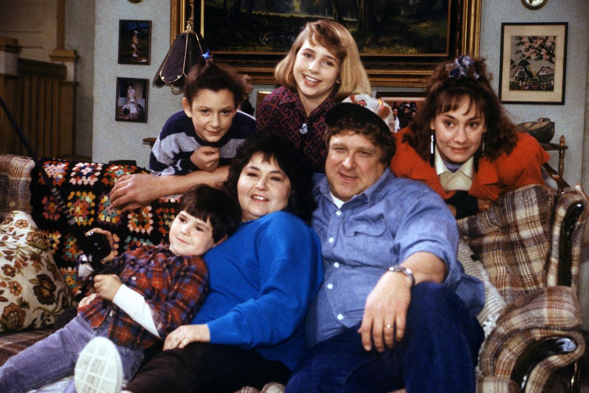 In this undated image released by ABC, shows the cast members of "Roseanne," Michael Fishman as DJ Conner, seated from left, Roseanne Barr as Roseanne Barr, John Goodman as Dan Conner, and second row from left, Sara Gilbert as Darlene Conner, Alicia Goranson as Becky Conner and Laurie Metcalf as Jackie Harris. The original cast of "Roseanne" will return to ABC two decades after it wrapped its hit series, the network said Tuesday in announcing its 2017-18 season plans. (Dan Watson / ABC)