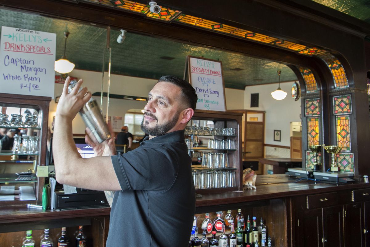 Lead bartender Nakia Salazar shakes a drink behind the bar at Kelly’s Bar and Restaurant in Newport, Washington, Thursday, Jan. 25, 2018. The bar has been in continuous operation since 1894. (Jesse Tinsley / The Spokesman-Review)
