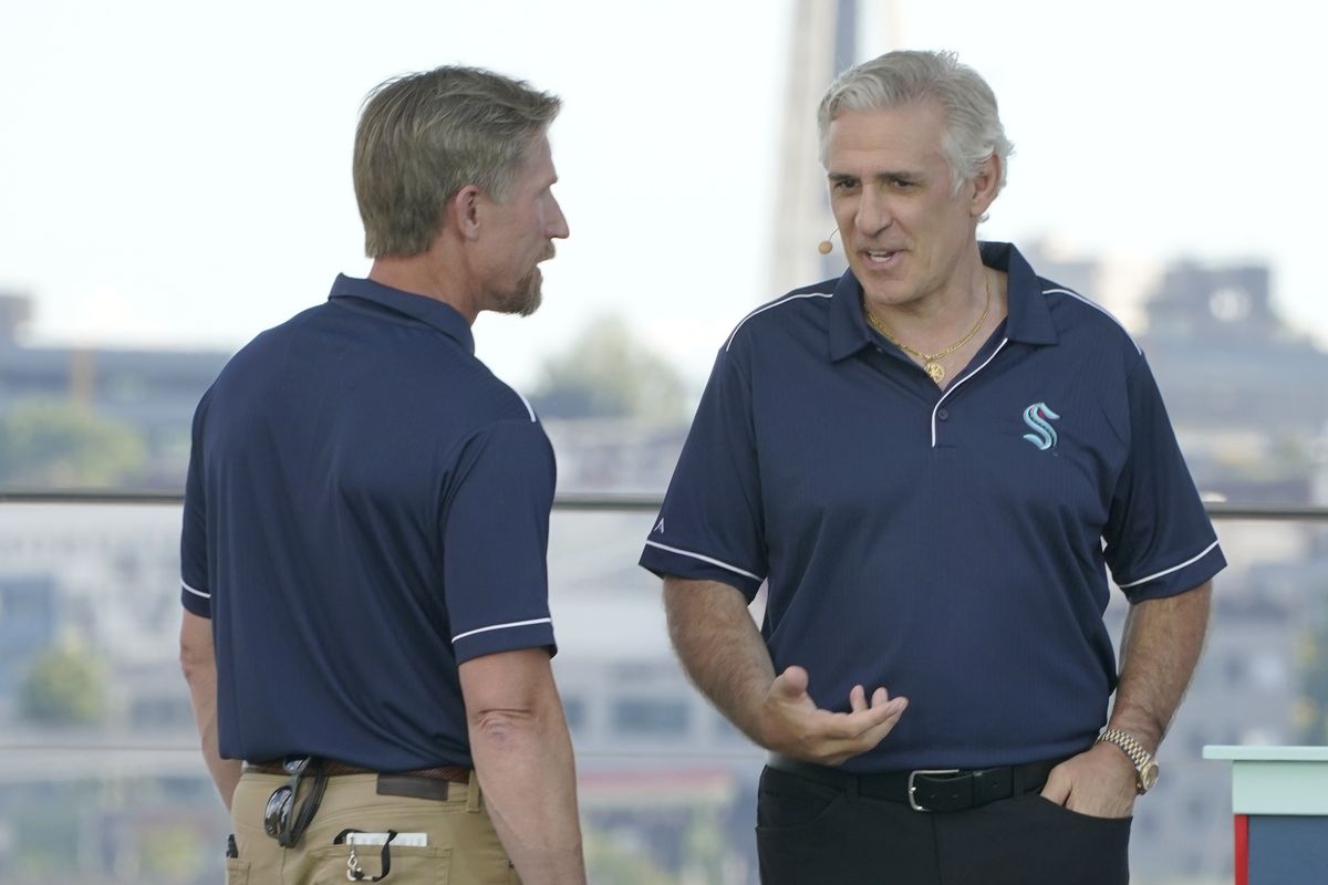 Seattle Kraken coach Dave Hakstol, left, talks with general manager Ron Francis on Wednesday, July 21, 2021, during the team's NHL hockey expansion draft event in Seattle.  (Associated Press)