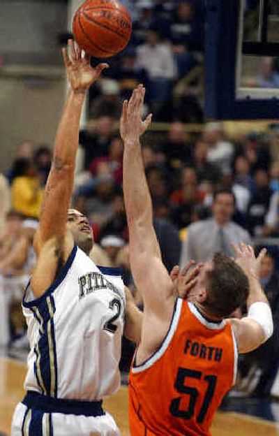 
Pittsburgh's Chevon Troutman, right, shoots over Syracuse's Craig Forth in the first half in Pittsburgh on Saturday.
 (Associated Press / The Spokesman-Review)