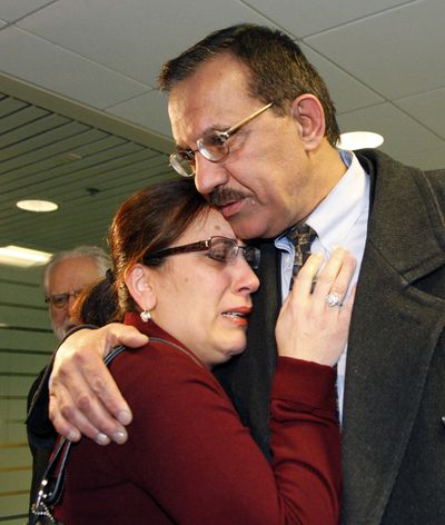 Jamal Tarhuni hugs his wife, Nariman Abdusamed, after his arrival at Portland International Airport Tuesday. Tarhuni and Mustafa Elogbi say they were subjected to an overzealous and groundless investigation in Tunisia by the FBI. (Associated Press)