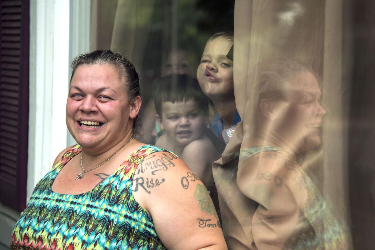 Sabrina Ryan grew up in the  West Central neighborhood, as did her mother and grandparents. When she was younger, she was a drug user, but has gotten clean and is actively involved in the community. She believes her story is indicative of the neighborhood at large. Her son, Jackson, goofs off in the window behind her. (Dan Pelle / The Spokesman-Review)