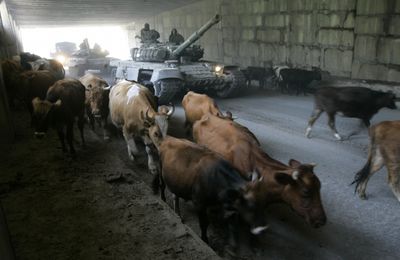 Russian armored vehicles enter a tunnel as they move through toward North Ossetia  on Sunday.  (Associated Press / The Spokesman-Review)