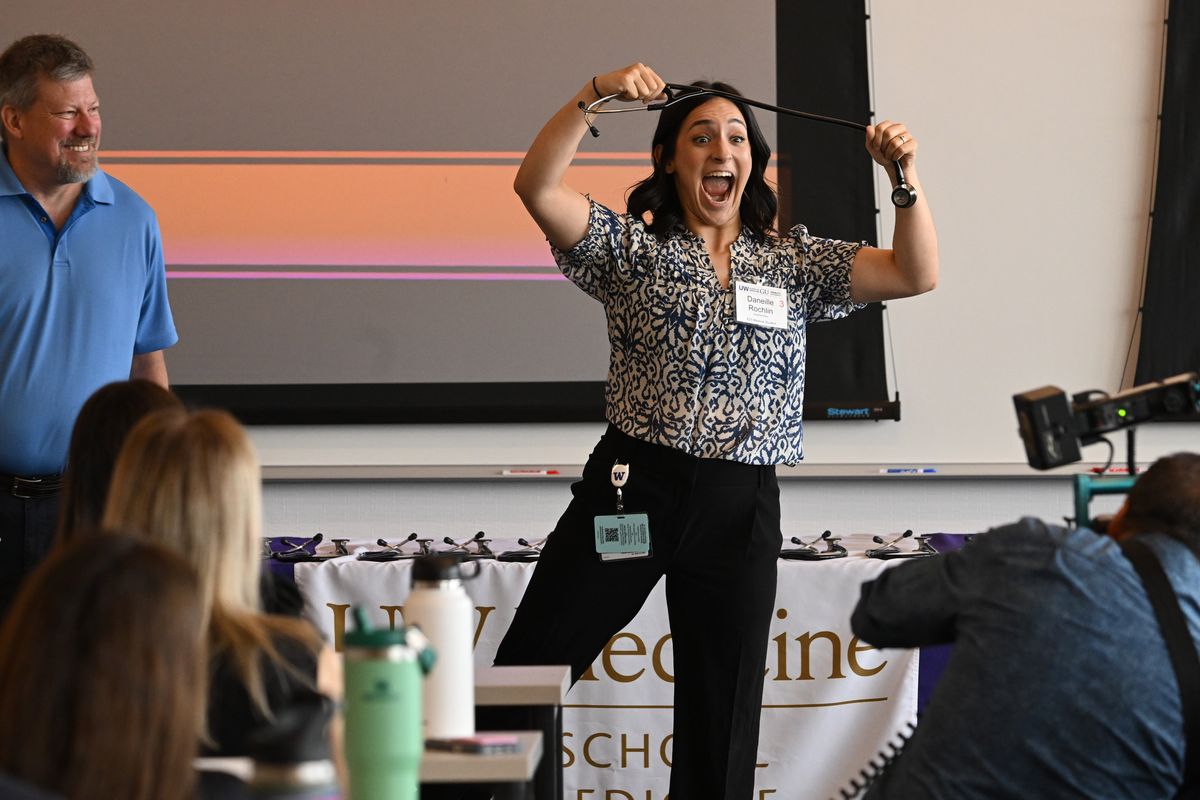 First-year medical student Danielle Rochlin celebrates her new stethoscope given by Dr. Geoff Jones, left, part of the alumni gift on July 10 to welcome new students to the University of Washington’s School of Medicine’s 2025 class. (Jesse Tinsley/THE SPOKESMAN-REVI)