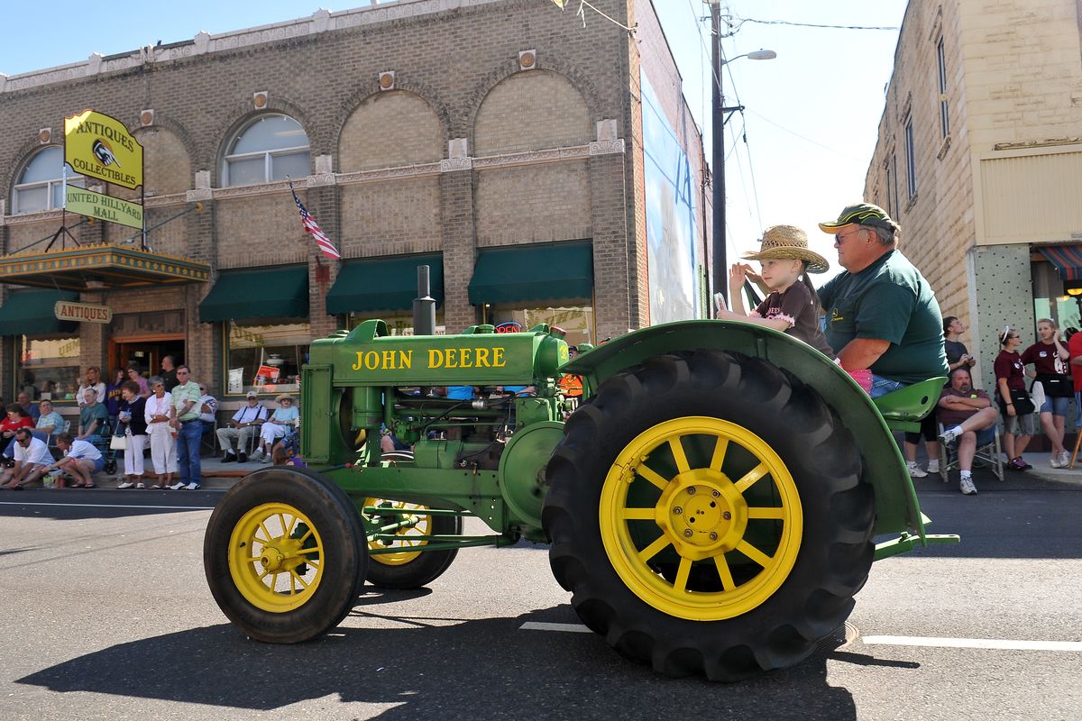 Greg Thomas, of Chattaroy, drives his 1937 John Deere tractor down Market Street in Hillyard with his granddaughter Lainee Shell, 5, in the Hillyard Hi-Jinks Parade on Saturday. The annual Hillyard Festival is celebrating its 100th incarnation. (Jesse Tinsley)