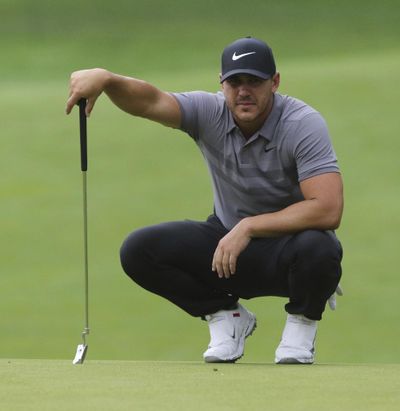 Brooks Koepka lines up a putt during a practice round for the Northern Trust golf tournament in Paramus, N.J., Wednesday, Aug. 22, 2018. (Chris Pedota / Record via AP)