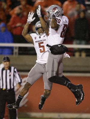 Cougars WR Dom Williams, right, celebrates with Rickey Galvin following Williams’ fourth-quarter TD on fourth and 14. (Associated Press)