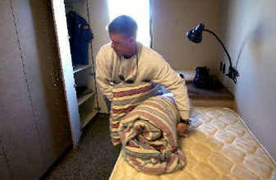 
Paramedic Jeff Powell puts his pillow and blanket in his locker in one of the dorm rooms at Fire Station 8 on North Wilbur Road in the Spokane Valley. The Valley Fire Department started operating from three new locations Tuesday. 
 (Liz Kishimoto / The Spokesman-Review)