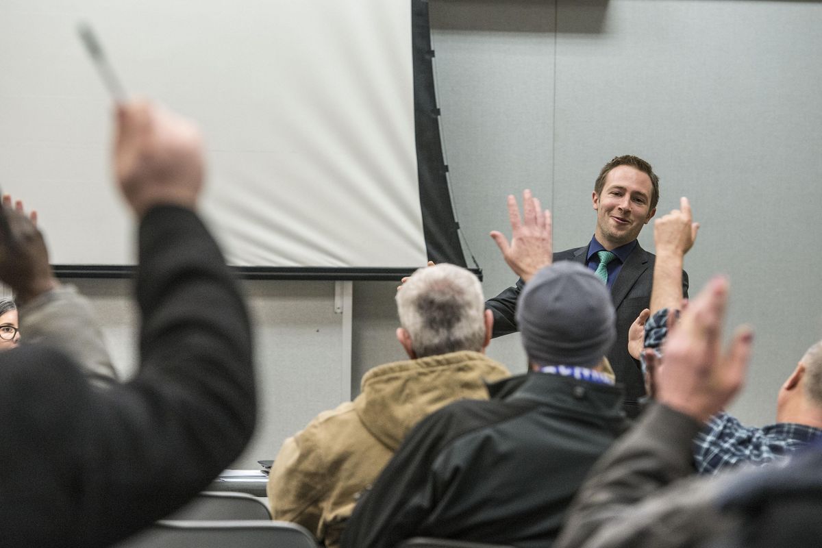 Attorney Alex Biel calls for a show of hands during his presentation Dec. 14, 2016, at the Center for Justice legal clinic at the Spokane Library in downtown Spokane, Washington. (Dan Pelle / The Spokesman-Review)