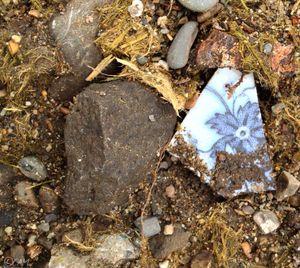 A broken piece of pottery on the ground beneath near the Monroe Street Bridge hint's at Spokane's past (Cheryl-Anne Millsap / photo by Cheryl-Anne Millsap)