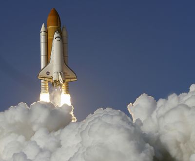 Space shuttle Discovery lifts off from the Kennedy Space Center in Cape Canaveral, Fla., in February. For $196 billion, the United States got five space shuttles and what will be 135 flights, when the last launch scheduled for Friday is included. (Associated Press)