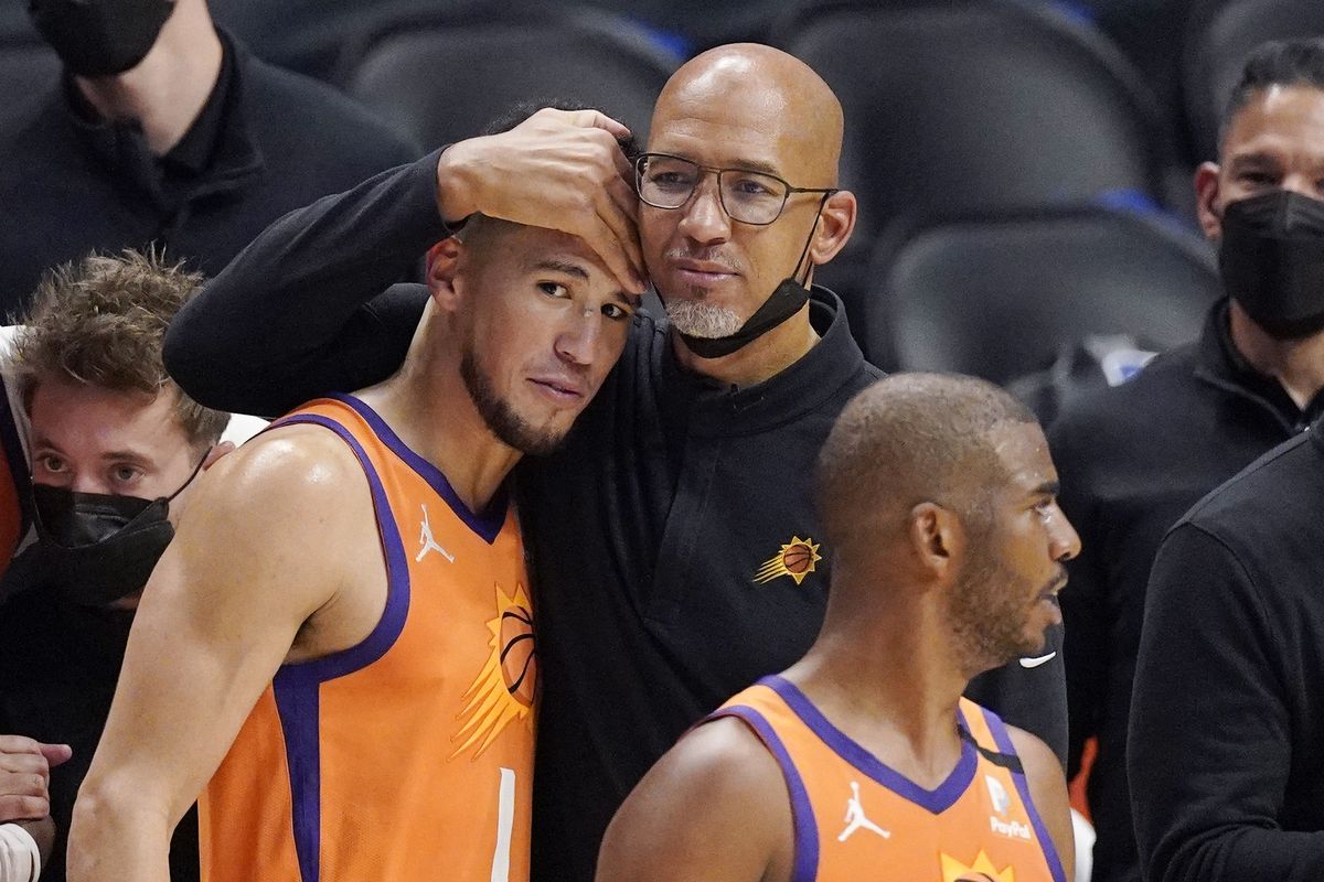 Phoenix Suns head coach Monty Williams, center, hugs Devin Booker, left, as Chris Paul stands by as time runs out in Game 6 of the NBA basketball Western Conference Finals against the Los Angeles Clippers Wednesday, June 30, 2021, in Los Angeles. The Suns won the game 130-103 to take the series 4-2.  (Mark J. Terrill)