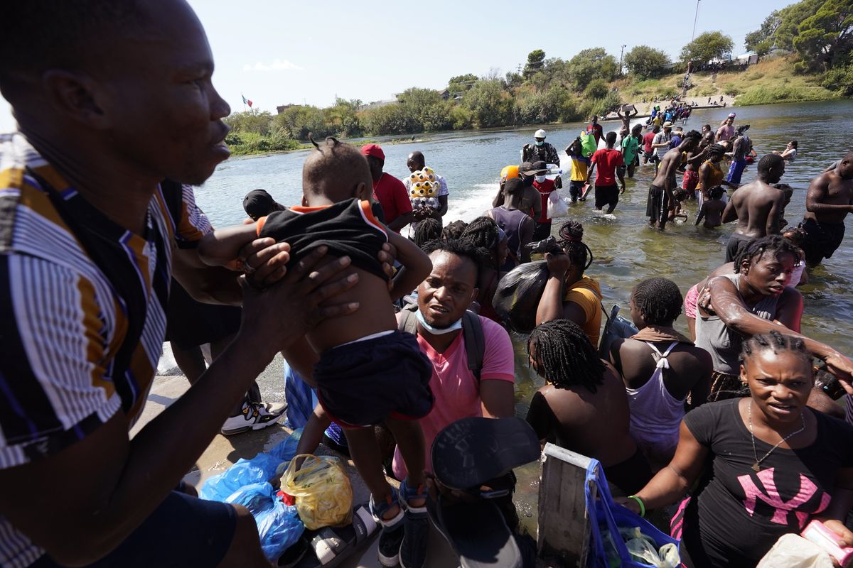 Haitian migrants use a dam to cross to and from the United States from Mexico, Friday, Sept. 17, 2021, in Del Rio, Texas. Thousands of Haitian migrants have assembled under and around a bridge in Del Rio presenting the Biden administration with a fresh and immediate challenge as it tries to manage large numbers of asylum-seekers who have been reaching U.S. soil.  (Eric Gay)