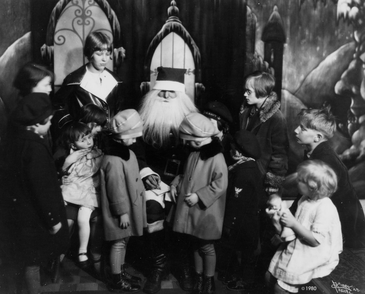 1927: The Santa Claus at the Palace Department Store in Spokane is surrounded by children waiting to tell him their Christmas list. The Santa Claus character became popular in the 1800s, following Clement Moore’s poem “A Visit From St. Nicholas” and influenced by many folkloric and religious traditions. Department store Santas date back to the mid-1800s. (Eastern Washington Historical Society archives / Libby Collection)