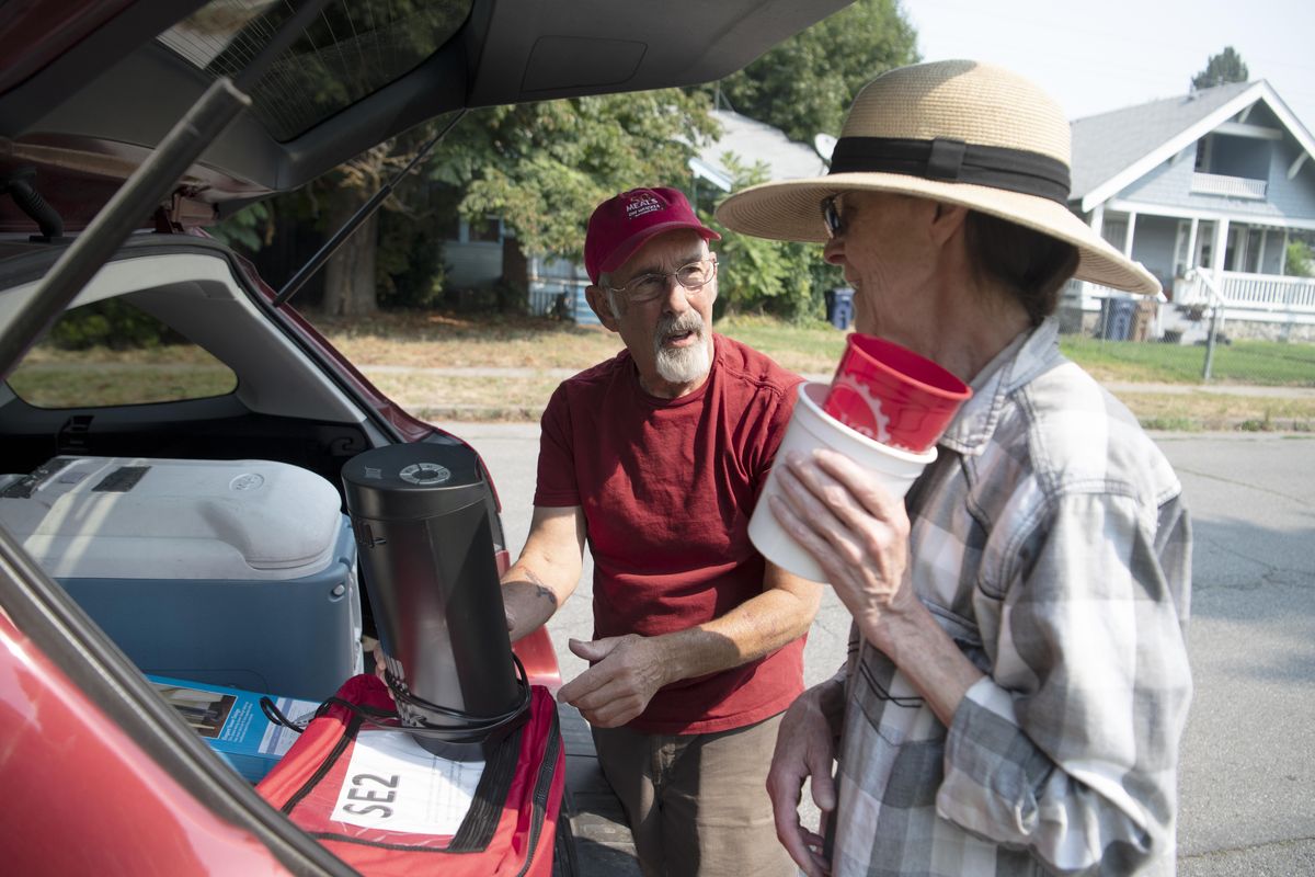 Meals on Wheels volunteer Howard Karnovsky, left, asks MOW client Theresa Press if she needs a fan to keep cool at her home in East Central Friday, Aug. 10, 2018. The MOW volunteers make a point of checking on their clients, especially in dangerously hot and cold weather. (Jesse Tinsley / The Spokesman-Review)