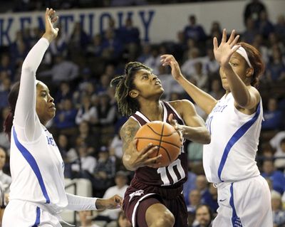 Mississippi State's Jazzmun Holmes, center, shoots between Kentucky's KeKe McKinney, left, and Nyah Tate, right, during the first quarter. (James Crisp / Associated Press)