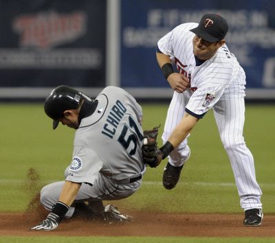 Seattle’s Ichiro Suzuki beats the tag of Minnesota’s Nick Punto to steal his 37th base of the season – second best in the A.L.  (Associated Press / The Spokesman-Review)