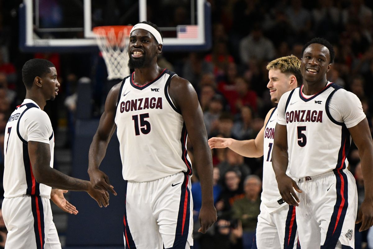 Gonzaga forwards Graham Ike, second from left, and Emmanuel Innocenti celebrate against Portland on Feb. 25 at McCarthey Athletic Center.  (Tyler Tjomsland / The Spokesman-Review)