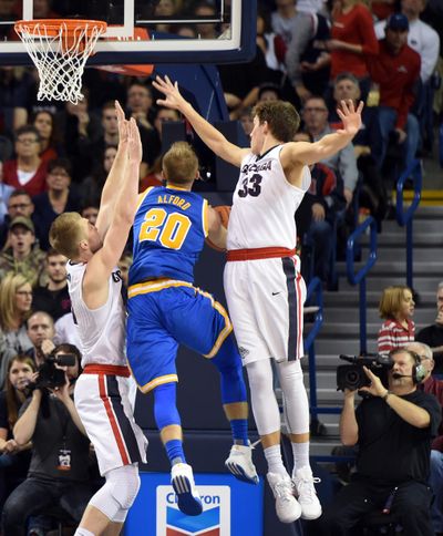 UCLA's Bryce Alford knifes between Gonzaga's Domantas Sabonis, left, and Kyle Wiltjer, right. The Gonzaga big men represent one of the strongest one-two punches in Zags’ history. (Jesse Tinsley / The Spokesman-Review)