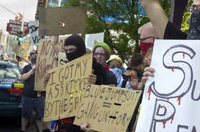 
Protesters line the sidewalks around Monroe Street and Mallon Avenue in Spokane on Monday. 
 (Christopher Anderson / The Spokesman-Review)