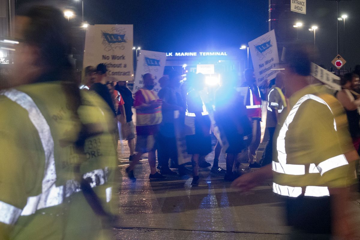 Striking longshoremen picket in front of the Dundalk Marine Terminal in Baltimore early Tuesday.  (Pete Voelker/for The Washington Post)