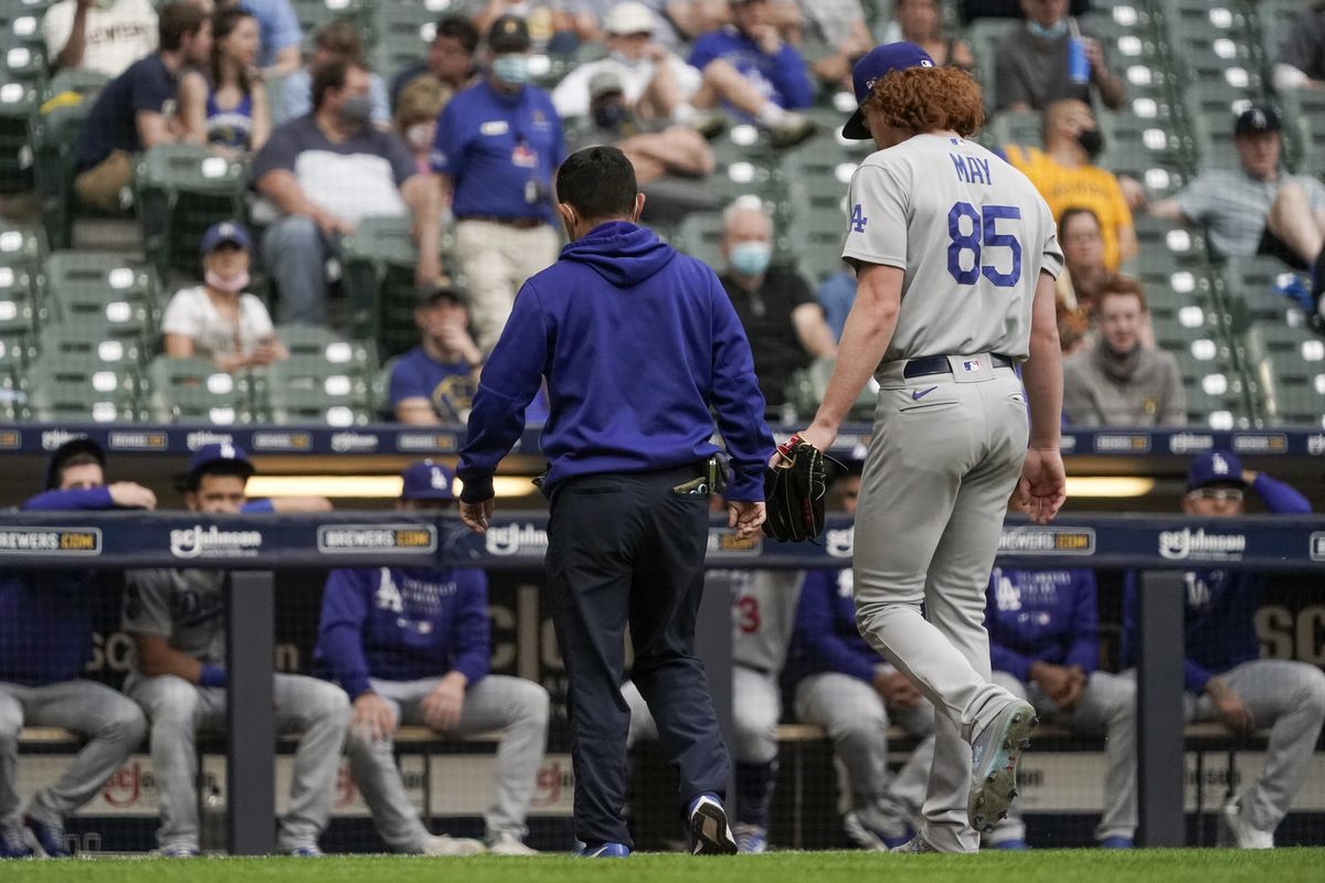 Los Angeles Dodgers starting pitcher Dustin May leaves the game after being injured during the second inning of a baseball game against the Milwaukee Brewers Saturday, May 1, 2021, in Milwaukee.  (Morry Gash)