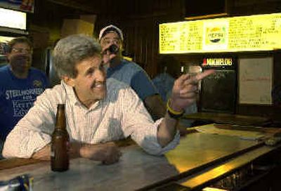 
 Sen. John Kerry, D-Mass., drinks a beer while visiting with locals Saturday at Abdalla's Tavern in Stratton, Ohio.
 (Associated Press / The Spokesman-Review)