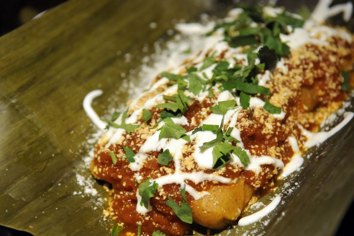 A smothered tamale is on the menu at El Que. The new bar and restaurant features various tequila infusions and taco truck food.