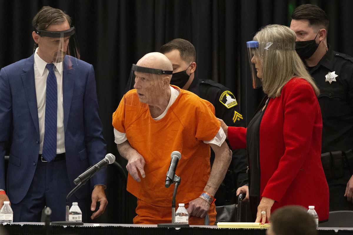 FILE - In this June 29, 2020, file photo, Joseph James DeAngelo, center, charged with being the Golden State Killer, is helped up by his attorney, Diane Howard, as Sacramento Superior Court Judge Michael Bowman enters the courtroom in Sacramento, Calif. Survivors plan to confront DeAngelo this week during an extraordinary four days of court hearings before the 74-year-old is sentenced to life in prison. (Rich Pedroncelli)