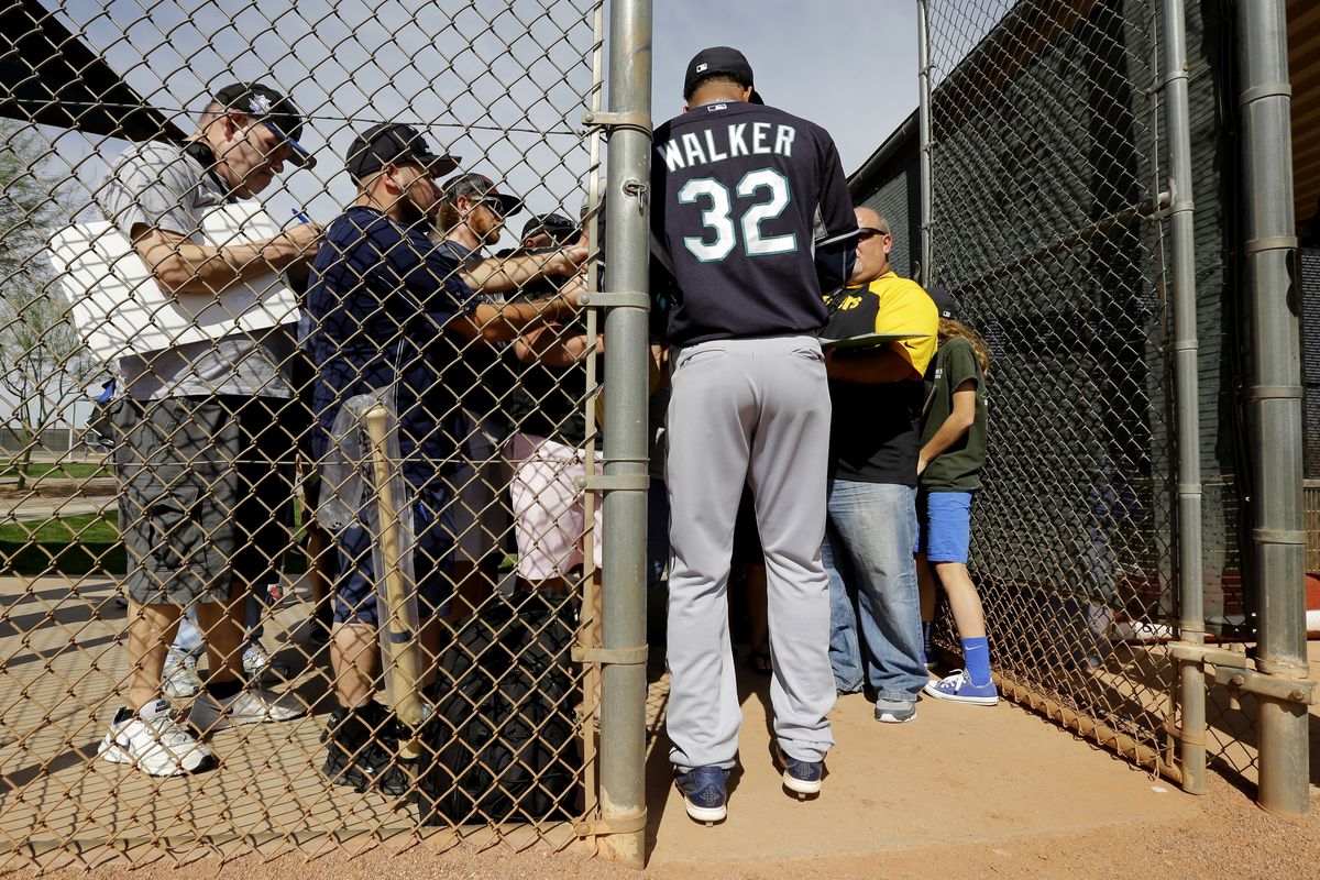Mariners pitcher Taijuan Walker, signing autographs at spring training, will start in the club’s Cactus League opener on Wednesday. (Associated Press)
