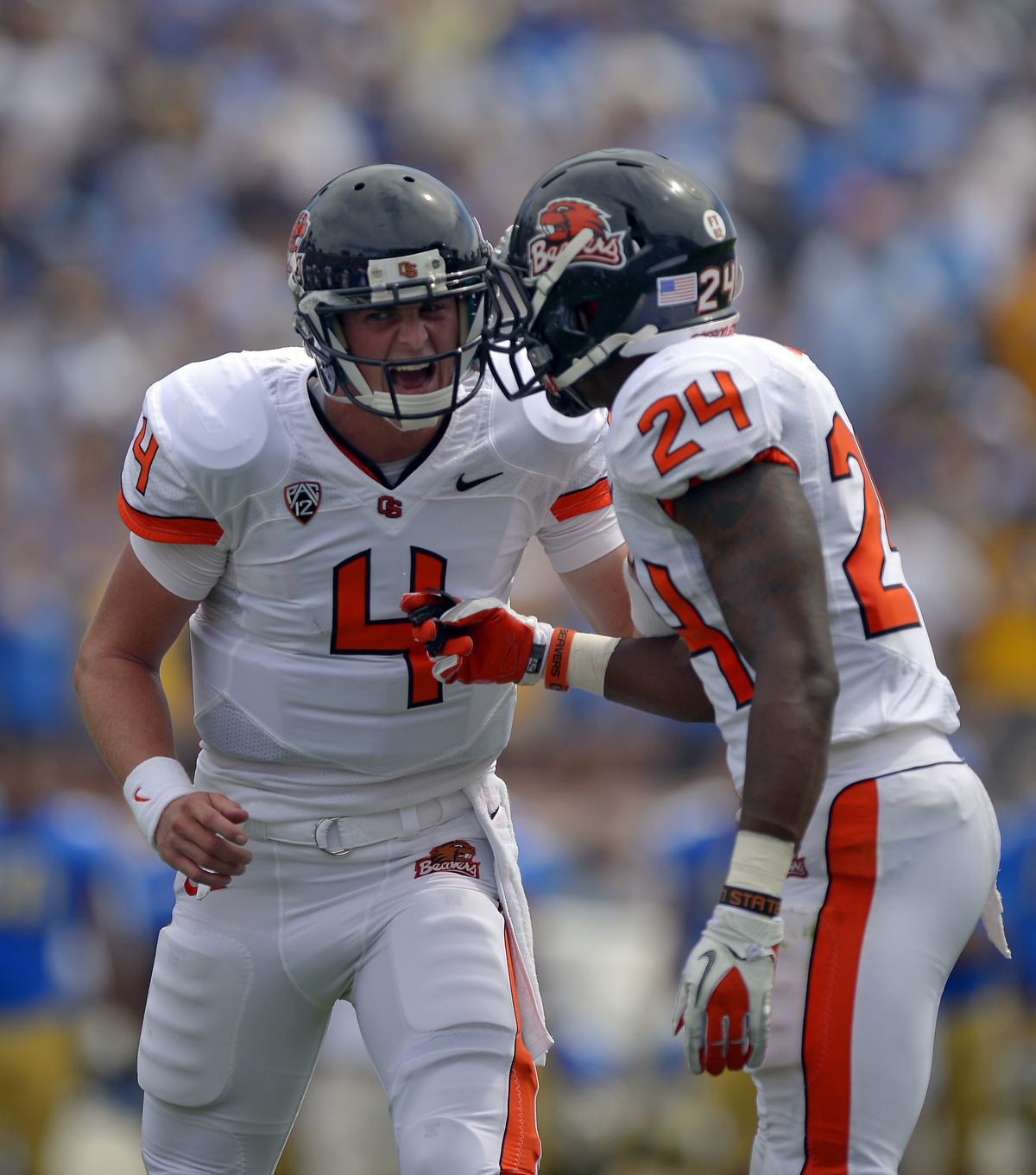 Sean Mannion, left, started strong for OSU, but will have to watch from the sidelines after injuring his knee. (Associated Press)