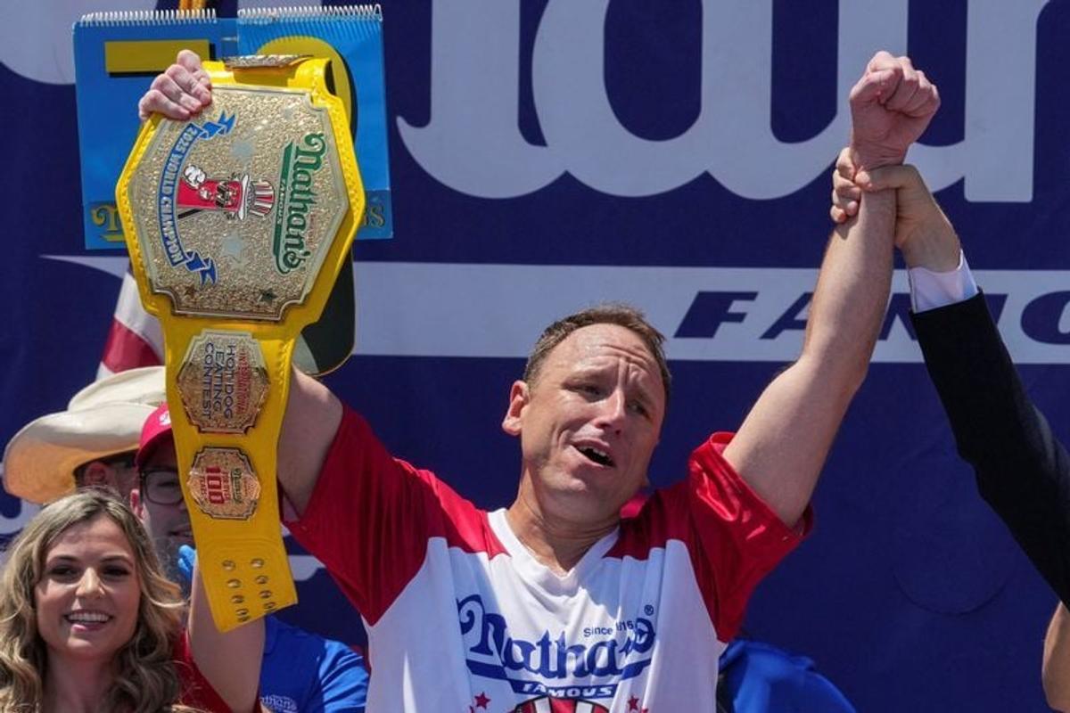 Joey Chestnut, a multi-time winner, holds the Mustard Belt, after winning the competition during the 2025 Nathan