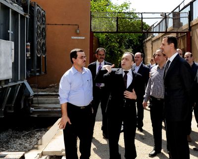 In this photo from Syria’s official news agency, President Bashar Assad, right, visits the Umayyad Electrical Station in Damascus on Wednesday. (Associated Press)