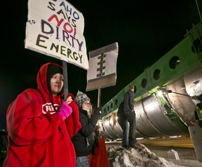 Megan Jeffs, 19, watches the controversial megaload move through Marsing, Idaho, on Saturday. (Associated Press)