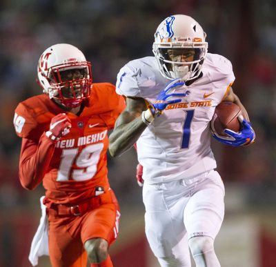 Boise State wide receiver Cedrick Wilson runs ahead of New Mexico defensive back Elijah Lilly on the way to one of three TD passes he caught from Brett Rypien. (Darin Oswald / Associated Press)