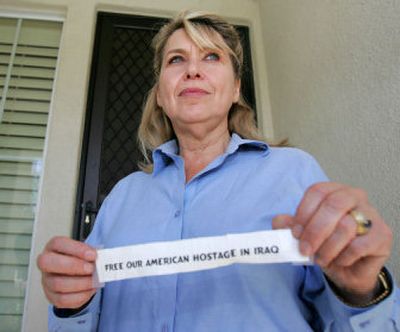 
Susan Hallums, ex-wife of Iraq hostage Roy Hallums, shows off a sign that's been in her window in Corona, Calif., for the last 10 months.  Hallums was released Wednesday. 
 (Associated Press / The Spokesman-Review)