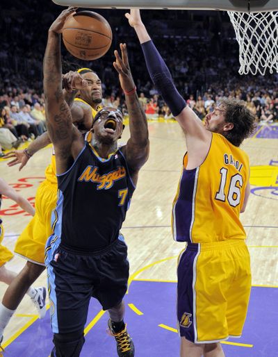 Denver Nuggets forward Al Harrington puts up a shot between the Lakers’ Pau Gasol, right, and Jordan Hill. (Associated Press)